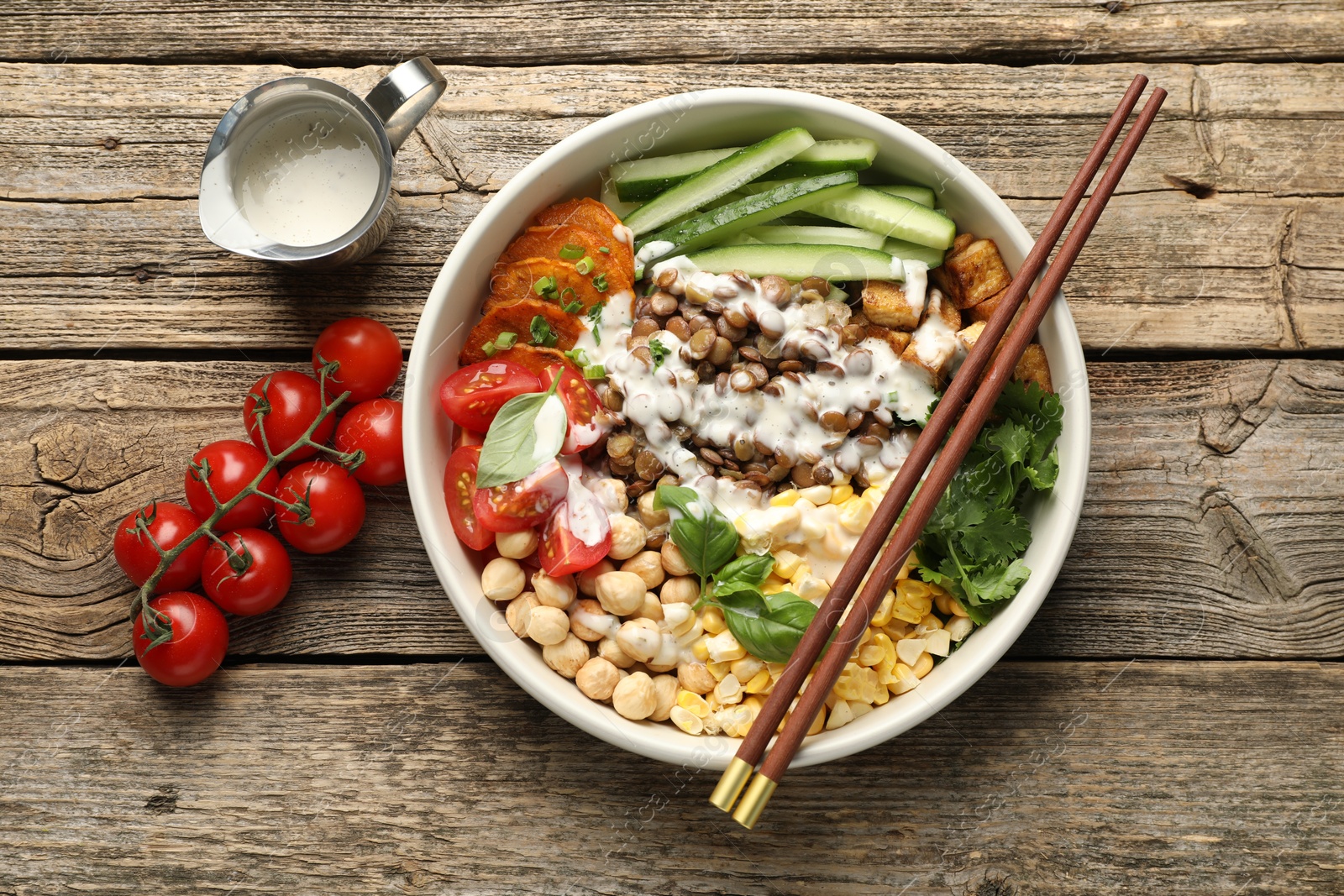 Photo of Healthy vegetarian food. Delicious Buddha bowl served on wooden table, flat lay