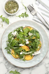 Photo of Tasty salad with arugula, cheese, peach, basil and spices on white marble table, flat lay
