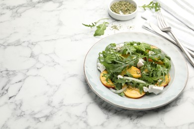 Photo of Tasty salad with arugula, cheese, peach, basil and spices on white marble table, closeup. Space for text
