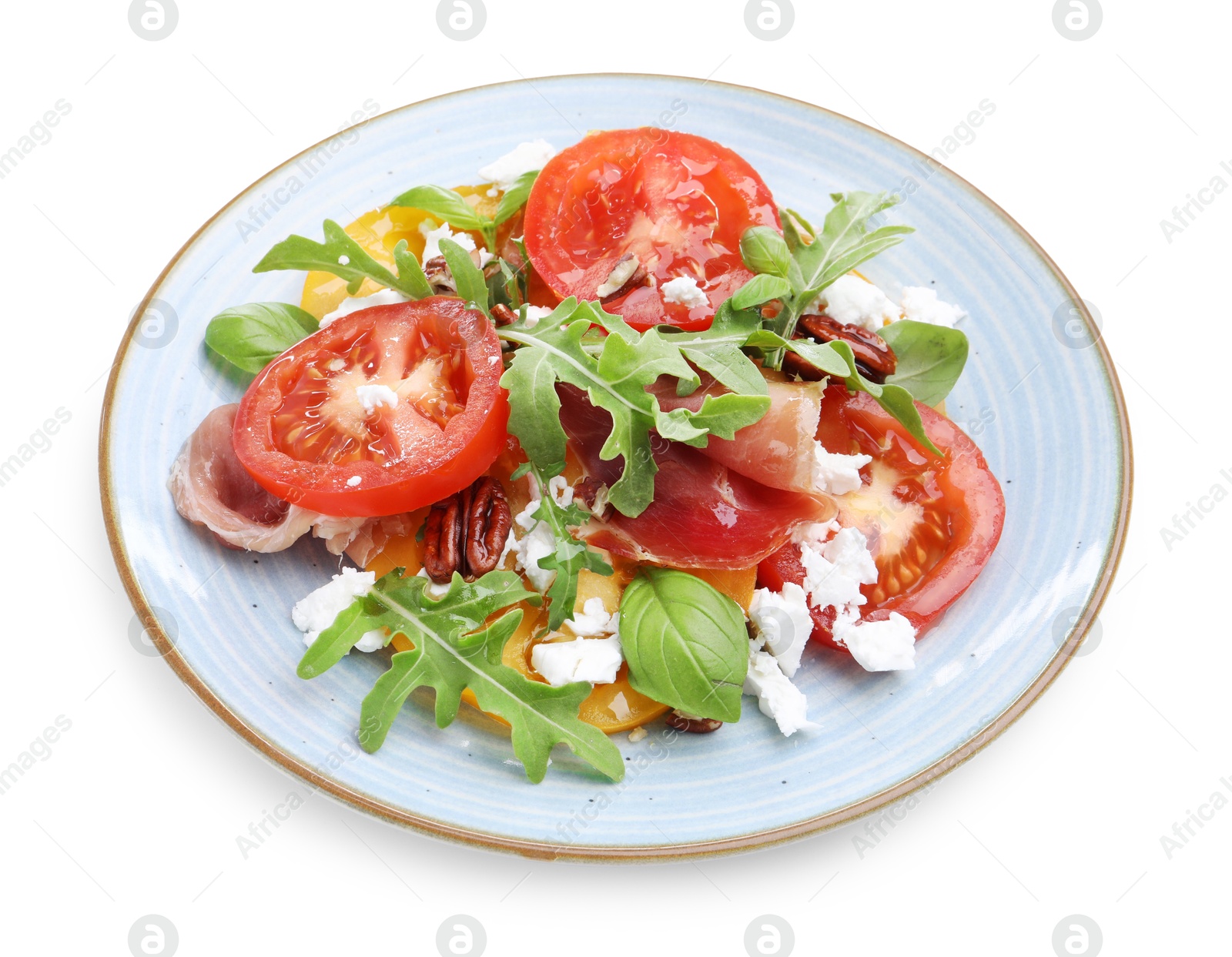 Photo of Tasty salad with arugula, cheese, tomatoes, nuts and prosciutto isolated on white