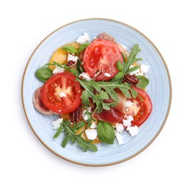 Photo of Tasty salad with arugula, cheese, tomatoes, nuts and prosciutto isolated on white, top view