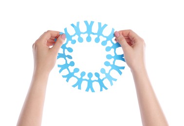 Photo of Woman holding paper figures of people on white background, closeup