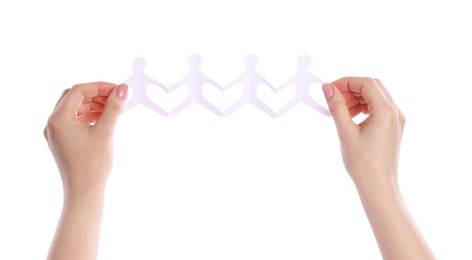 Photo of Woman holding paper figures of people on white background, closeup