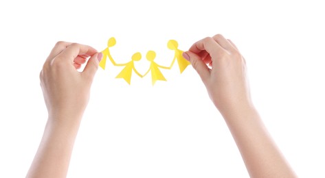 Photo of Woman holding paper figures of people on white background, closeup