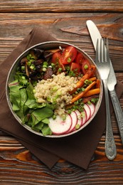 Photo of Healthy vegetarian food. Delicious Buddha bowl with quinoa, mushrooms and vegetables on wooden table, flat lay