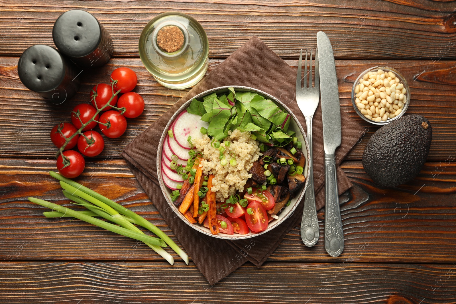 Healthy vegetarian food. Delicious Buddha bowl and ingredients on wooden table, flat lay Photo of Healthy vegetarian food. Delicious Buddha bowl and ingredients on wooden table, flat lay