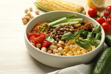 Photo of Healthy vegetarian food. Delicious Buddha bowl and ingredients on light wooden table, closeup. Space for text