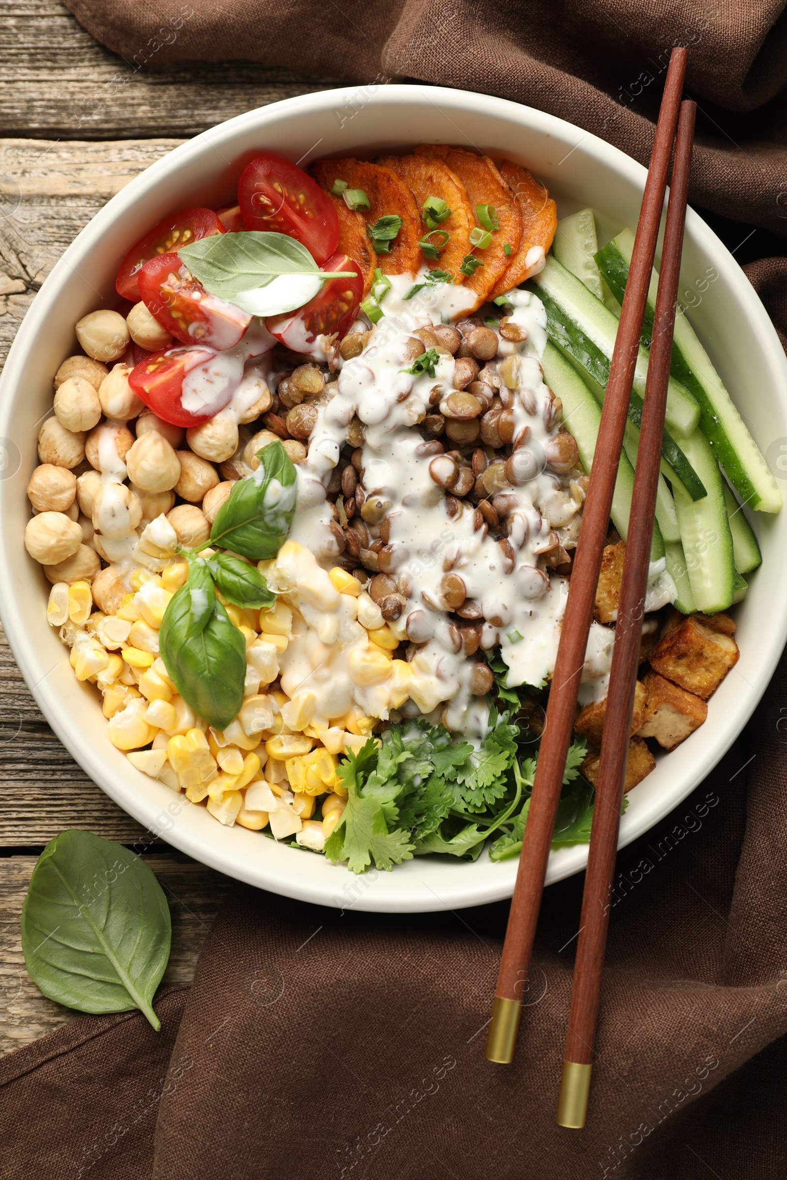 Healthy vegetarian food. Delicious Buddha bowl served on wooden table, top view Photo of Healthy vegetarian food. Delicious Buddha bowl served on wooden table, top view