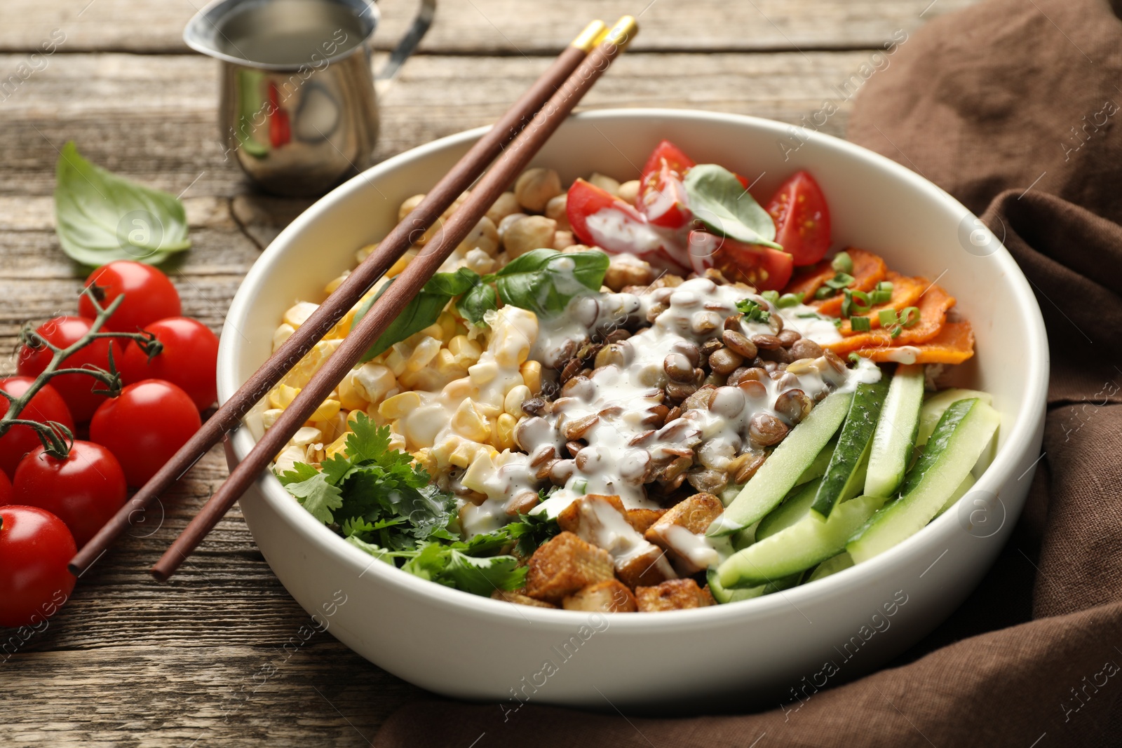 Healthy vegetarian food. Delicious Buddha bowl served on wooden table, closeup Photo of Healthy vegetarian food. Delicious Buddha bowl served on wooden table, closeup