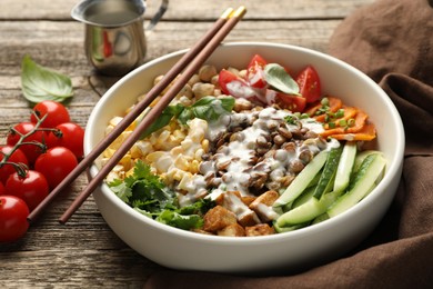 Photo of Healthy vegetarian food. Delicious Buddha bowl served on wooden table, closeup