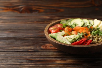 Photo of Healthy vegetarian food. Delicious Buddha bowl with lentils, tofu and vegetables on wooden table, closeup. Space for text