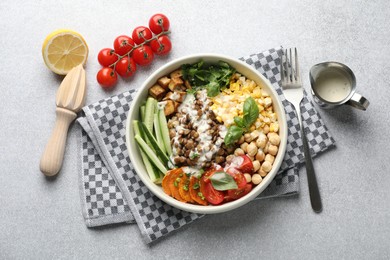 Photo of Healthy vegetarian food. Delicious Buddha bowl served on light grey table, flat lay
