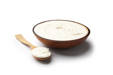 Photo of Delicious sour cream in bowl and spoon isolated on white