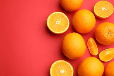 Photo of Fresh ripe oranges on red background, flat lay. Space for text