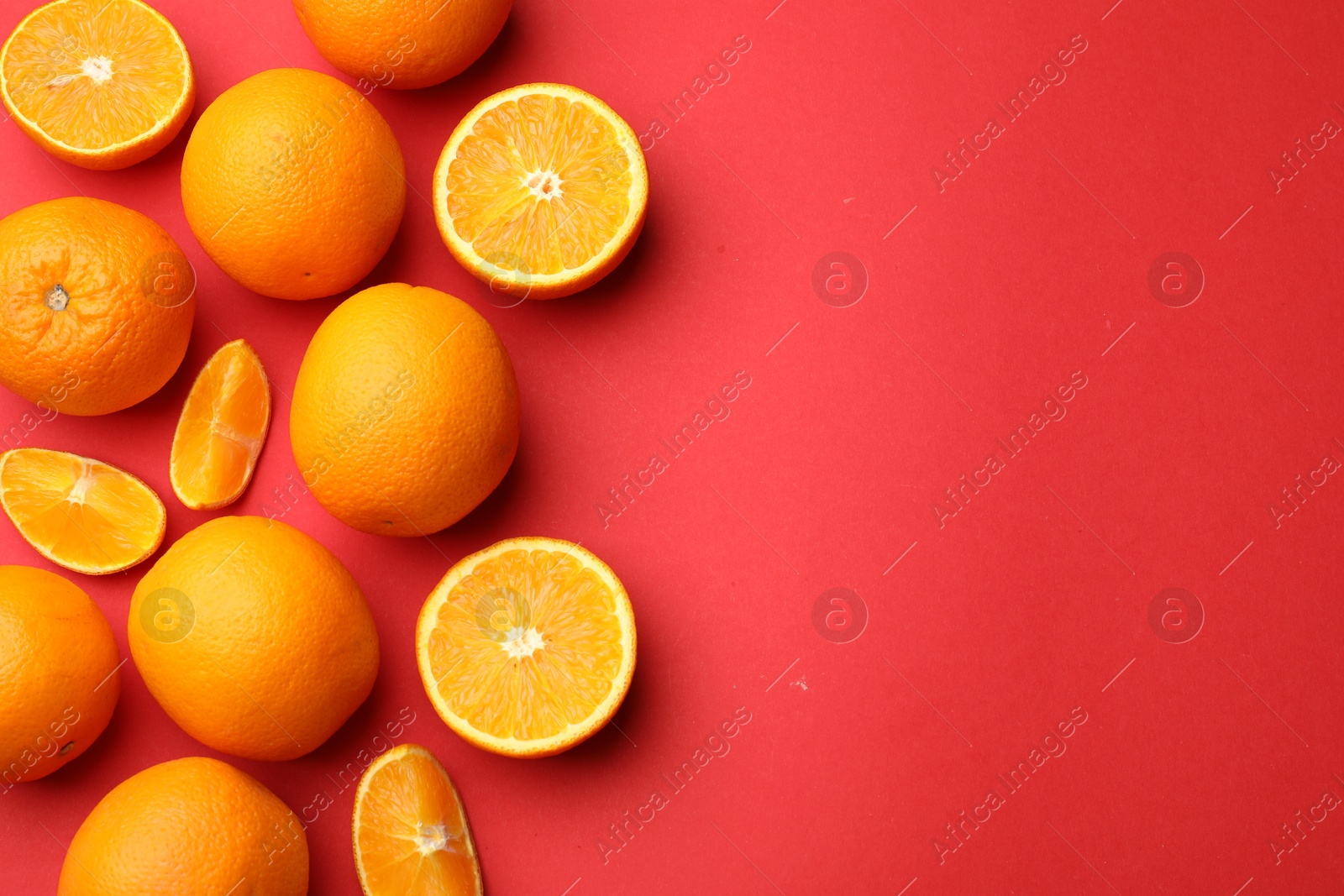 Fresh ripe oranges on red background, flat lay. Space for text Photo of Fresh ripe oranges on red background, flat lay. Space for text