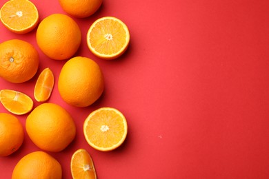 Photo of Fresh ripe oranges on red background, flat lay. Space for text