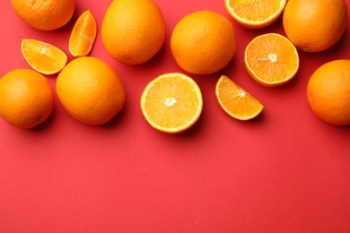 Photo of Fresh ripe oranges on red background, flat lay. Space for text