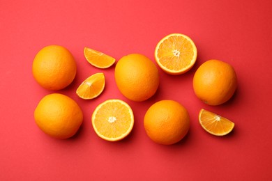 Photo of Fresh ripe oranges on red background, flat lay