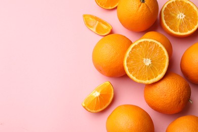 Photo of Fresh ripe oranges on pink background, flat lay. Space for text