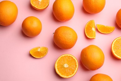 Photo of Fresh ripe oranges on pink background, flat lay