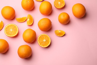 Photo of Fresh ripe oranges on pink background, flat lay. Space for text