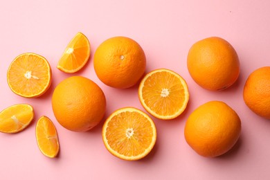 Photo of Fresh ripe oranges on pink background, flat lay