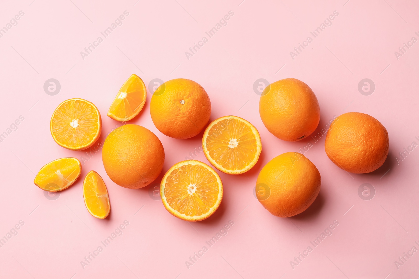 Photo of Fresh ripe oranges on pink background, flat lay