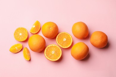 Photo of Fresh ripe oranges on pink background, flat lay
