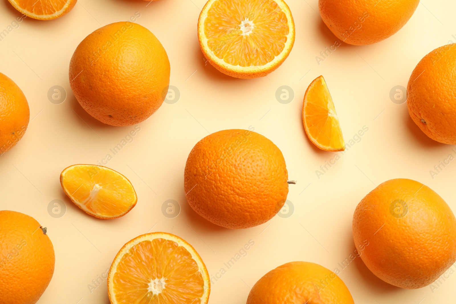 Photo of Fresh ripe oranges on beige background, flat lay