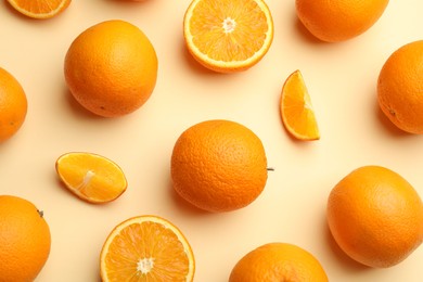 Photo of Fresh ripe oranges on beige background, flat lay