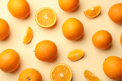 Photo of Fresh ripe oranges on beige background, flat lay