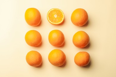 Photo of Fresh ripe oranges on beige background, flat lay