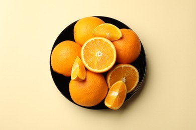 Photo of Fresh ripe oranges on beige background, top view