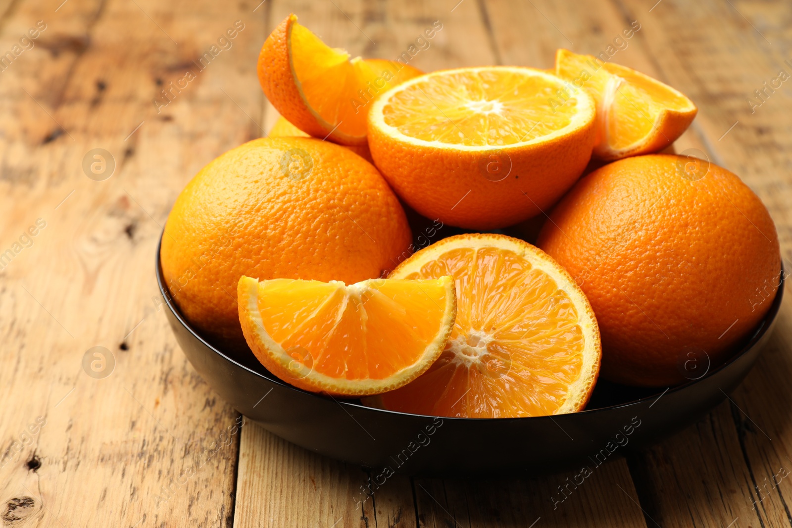 Photo of Fresh ripe oranges on wooden table, closeup