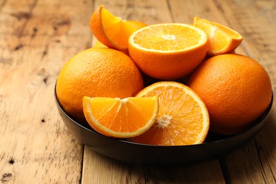 Photo of Fresh ripe oranges on wooden table, closeup