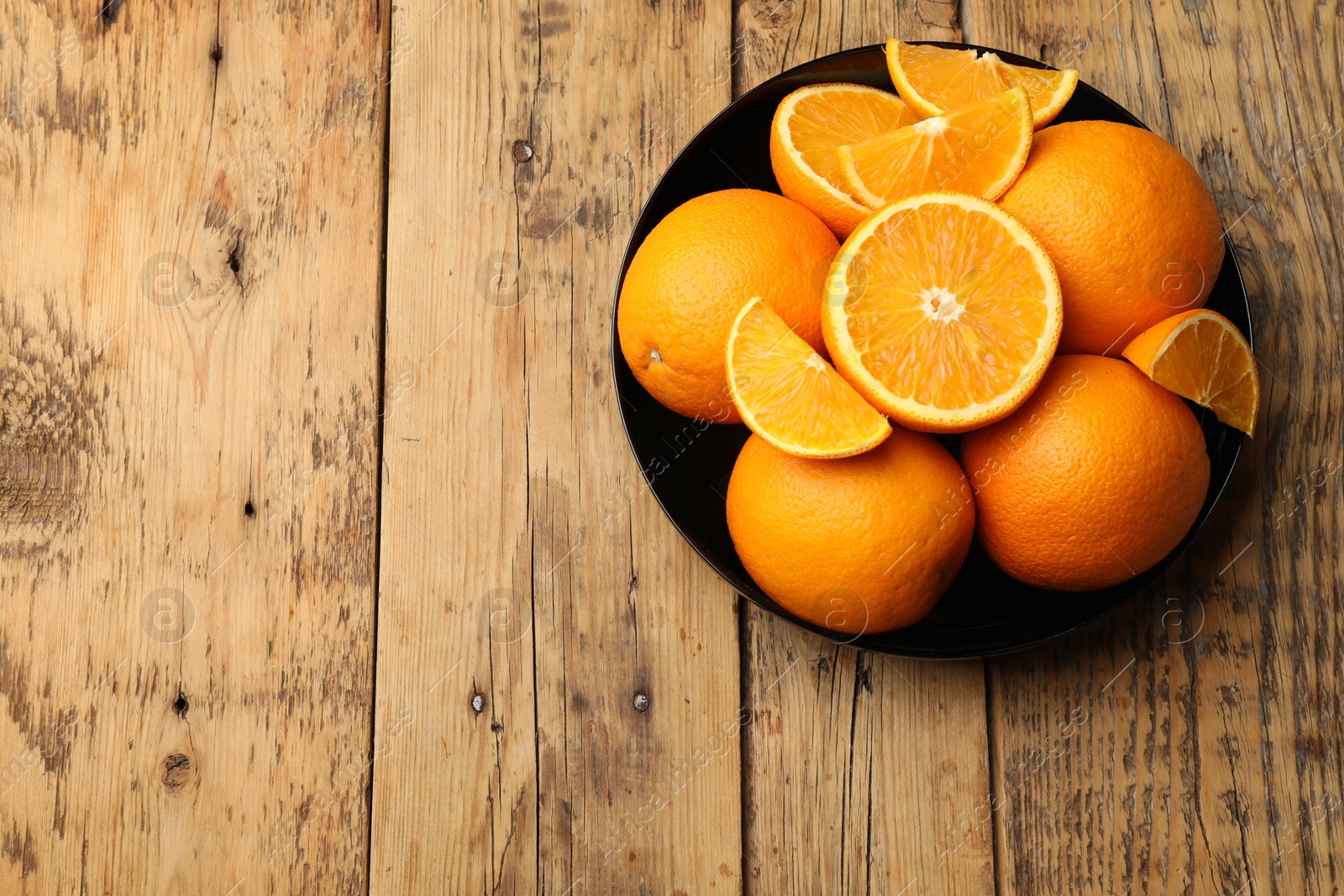 Fresh ripe oranges on wooden table, top view. Space for text Photo of Fresh ripe oranges on wooden table, top view. Space for text
