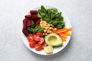 Photo of Different healthy vegetarian food on light grey table, top view