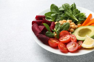 Photo of Different healthy vegetarian food on light grey table, closeup. Space for text