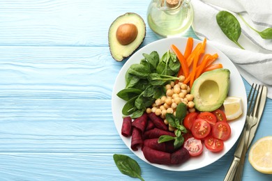 Photo of Different healthy vegetarian food served on light blue wooden table, flat lay. Space for text