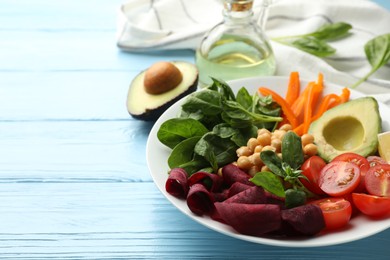 Photo of Different healthy vegetarian food on light blue wooden table, closeup. Space for text