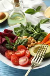 Photo of Different healthy vegetarian food on light blue wooden table, closeup