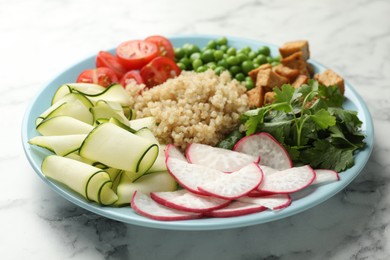 Photo of Different healthy vegetarian food on white marble table, closeup