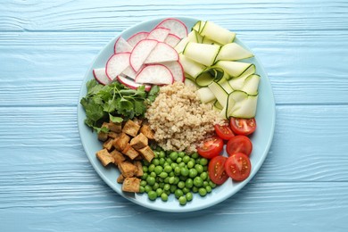 Photo of Different healthy vegetarian food on light blue wooden table, top view