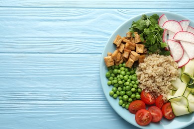 Photo of Different healthy vegetarian food on light blue wooden table, top view. Space for text