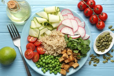 Photo of Different healthy vegetarian food served on light blue wooden table, flat lay