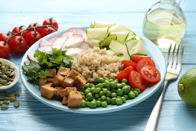 Photo of Different healthy vegetarian food served on light blue wooden table, closeup