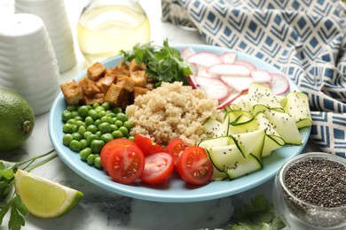 Photo of Different healthy vegetarian food served on white marble table, closeup