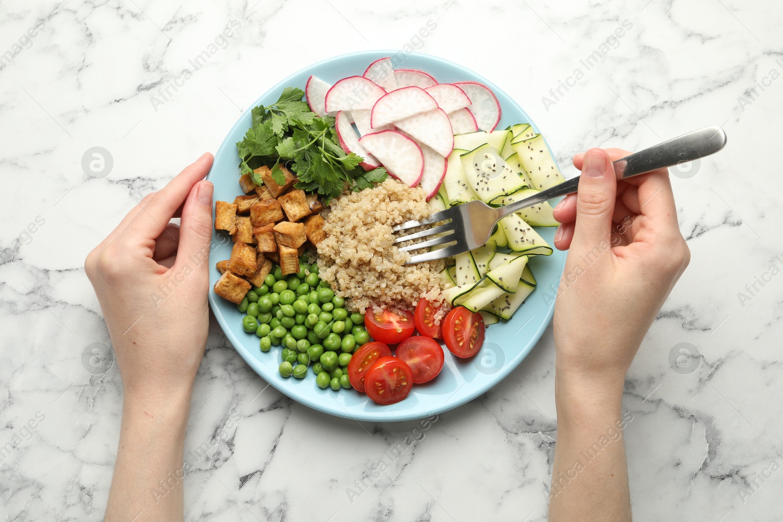 Woman eating different healthy vegetarian food at white marble table, top view Photo of Woman eating different healthy vegetarian food at white marble table, top view