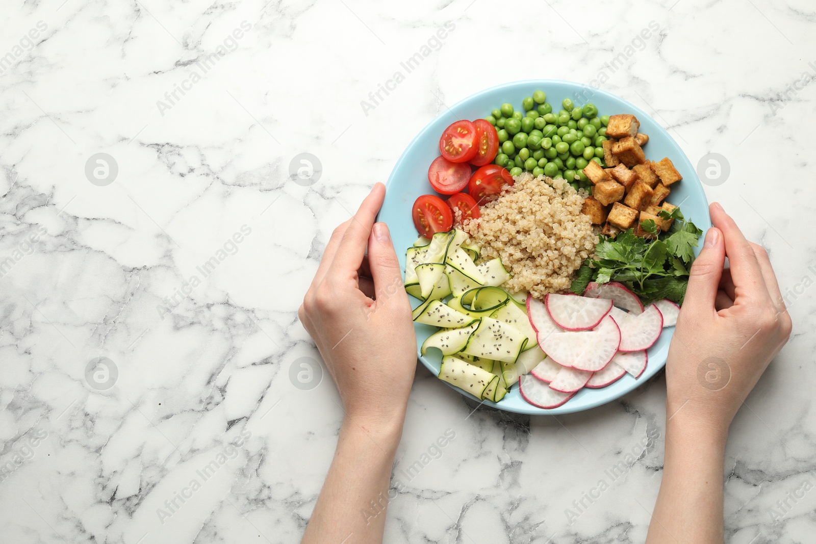 Woman with different healthy vegetarian food at white marble table, top view. Space for text Photo of Woman with different healthy vegetarian food at white marble table, top view. Space for text