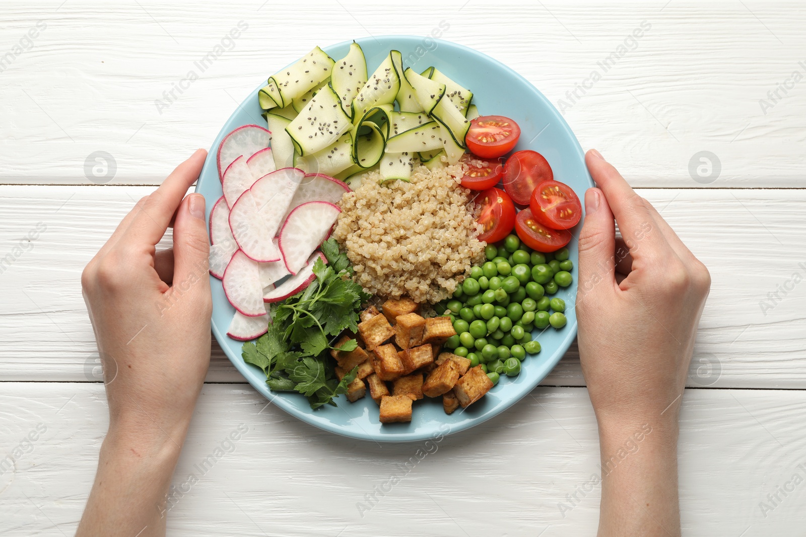 Woman with different healthy vegetarian food at white wooden table, top view Photo of Woman with different healthy vegetarian food at white wooden table, top view